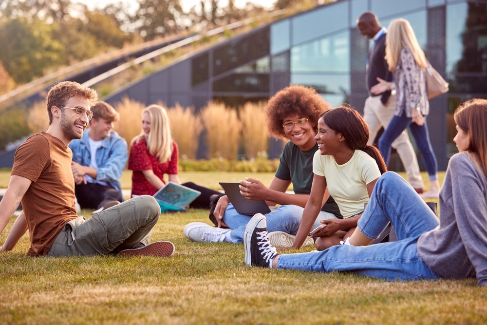 group of college students sitting outside