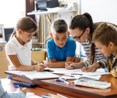 students and teacher working together in classroom