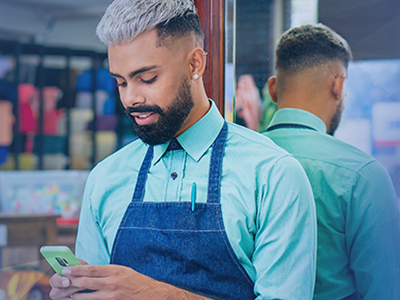 retail employee looking at phone