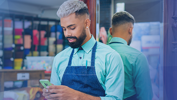 Retail worker looking at phone